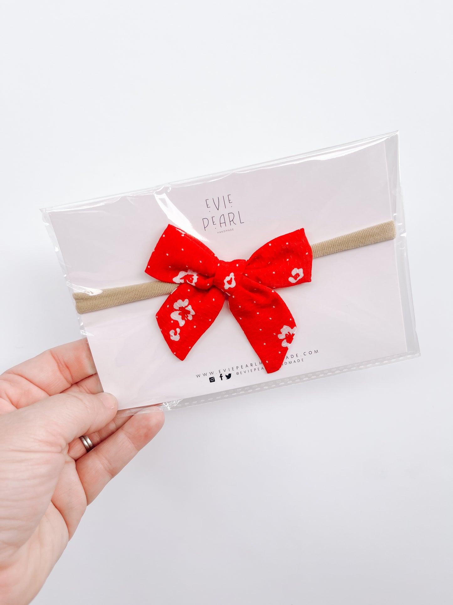 Small red floral bow on nylon headband