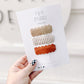 Close-up of handmade fall neutral stripe scalloped snap clips – 1.25 x 2.25 inches