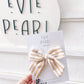 Close-up of cream and yellow striped large pinwheel bow 4 x 5 inches with secure alligator clip