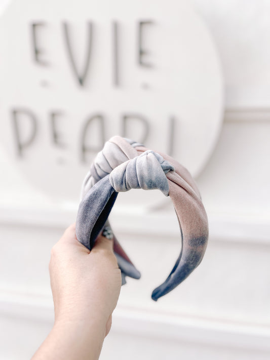 Close-up of soft neutral tie-dye fabric knotted headband – beige and cream hair accessory for women and girls.