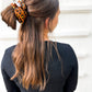 Close-up of silk satin leopard scrunchie – available in regular and oversized sizes for women and girls 