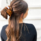 Oversized silk leopard scrunchie styled in ponytail – smooth satin animal print hair tie for all ages