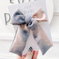 Close-up of fall neutral tiedye longtailed bow mix of gray and black tones with secure alligator clip