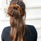 Oversized silk leopard scrunchie styled in ponytail – smooth satin animal print hair tie for all ages