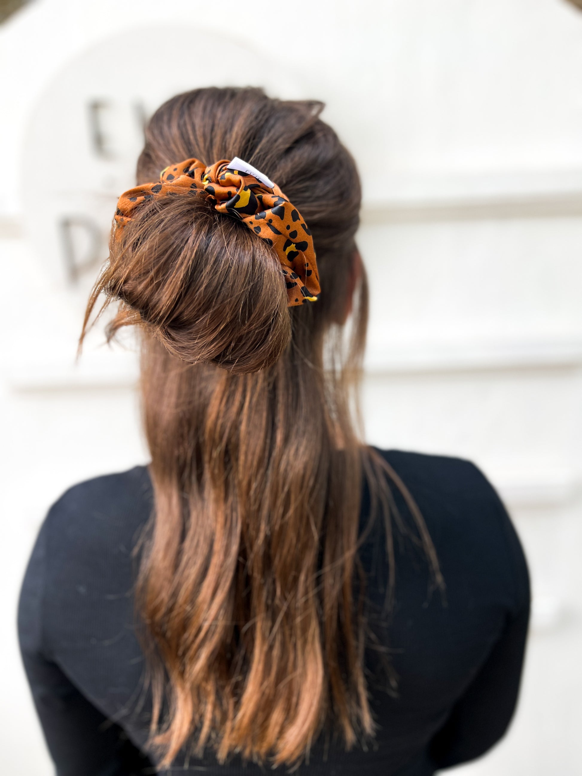 Oversized silk leopard scrunchie styled in ponytail – smooth satin animal print hair tie for all ages