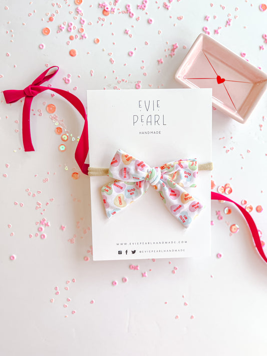 Pastel Conversation Hearts Small Bow On Nylon Headband