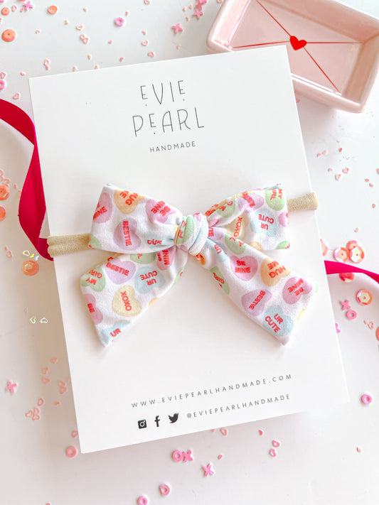 Pastel Conversation Hearts Small Bow On Nylon Headband