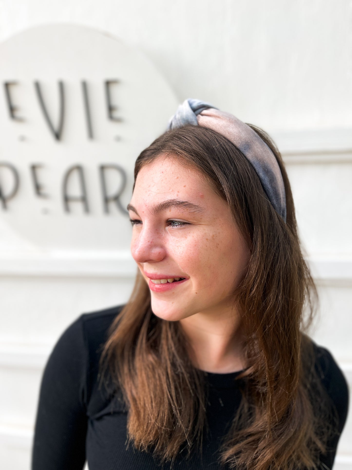 Teen wearing neutral beige and cream tie-dye knotted headband – soft handmade hair accessory for all ages