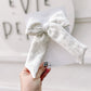 Close-up of soft gray sweatshirt fabric long tailed bow neutral hair accessory for year round wear